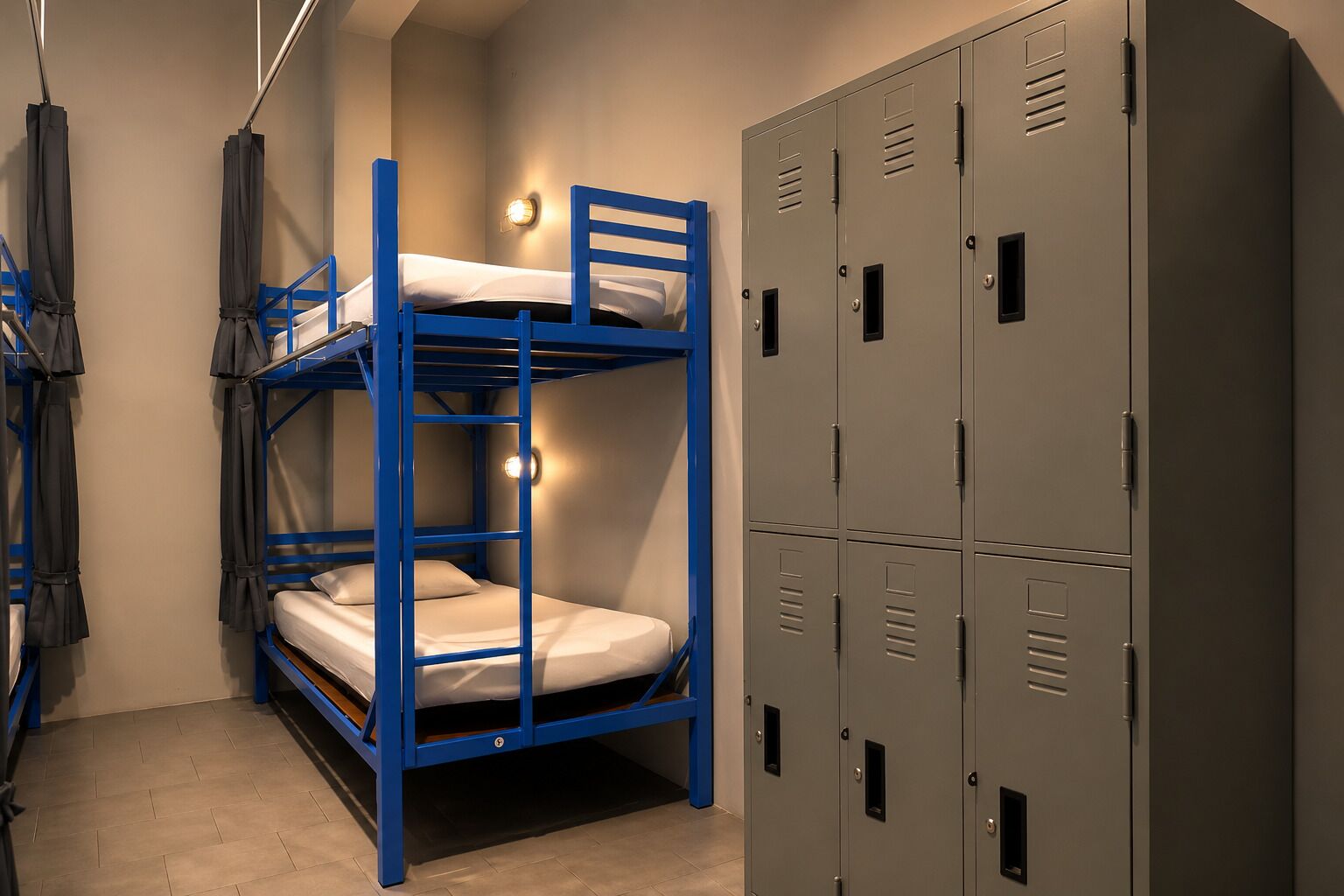 A bunk bed with a ladder, a wall-mounted light, and a set of grey lockers.