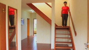 A staircase with wooden steps and a handrail, leading to an upper floor.