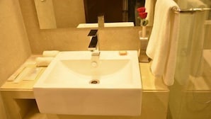 Ein Badezimmer mit Waschbecken, Spiegel und Handtuchhalter.
