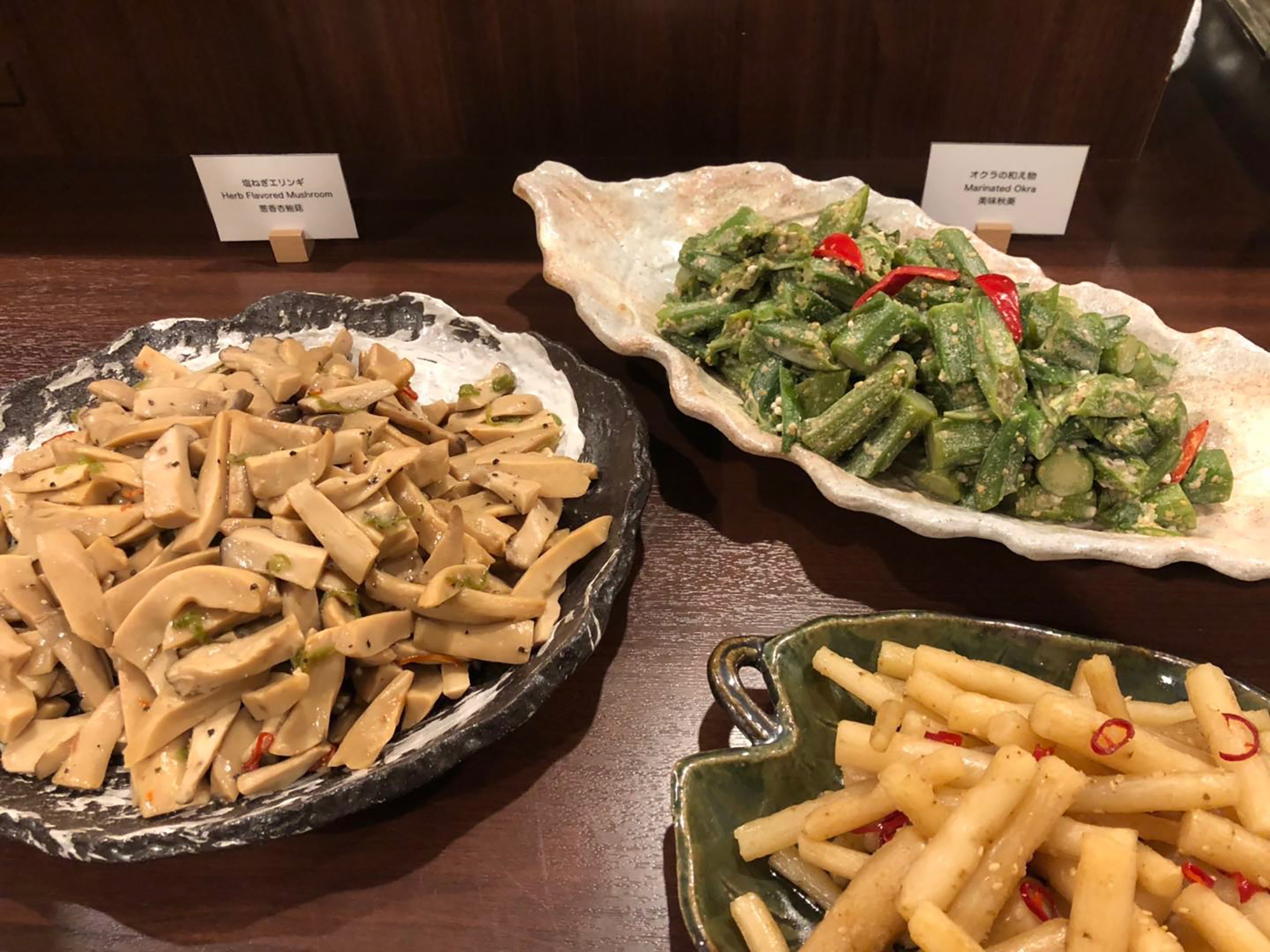Tres plats: un bol de bolets tallats, un bol de verdures i un bol de pasta.