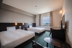 A hotel room with two beds, a desk, a chair, a window with a view, and a bathroom. - Spring Sunny Hotel Nagoya Tokoname (Tokoname)