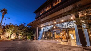 A building with a modern entrance, large glass doors, and a covered walkway.