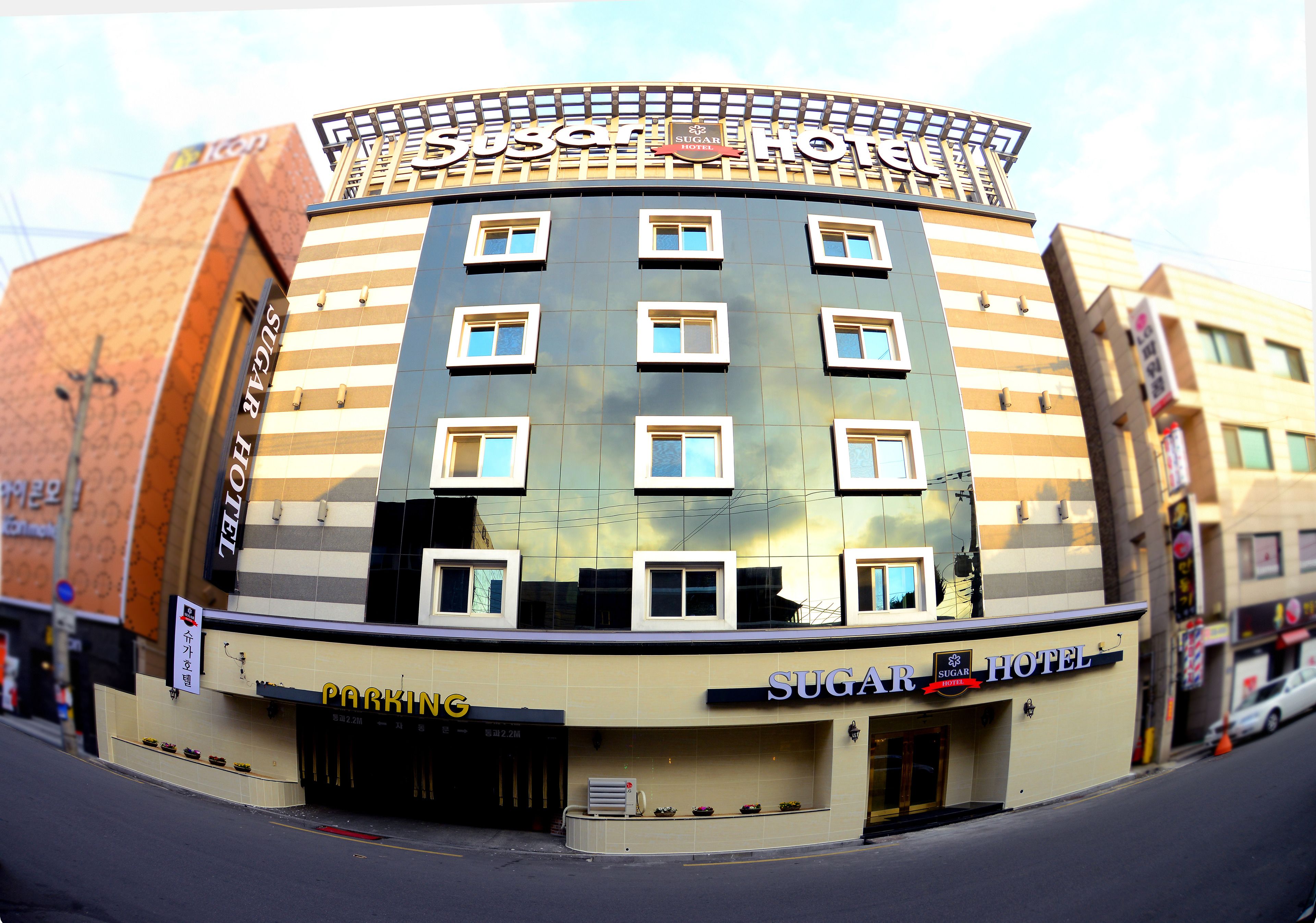 A hotel with a modern design, featuring multiple floors and a prominent signage.