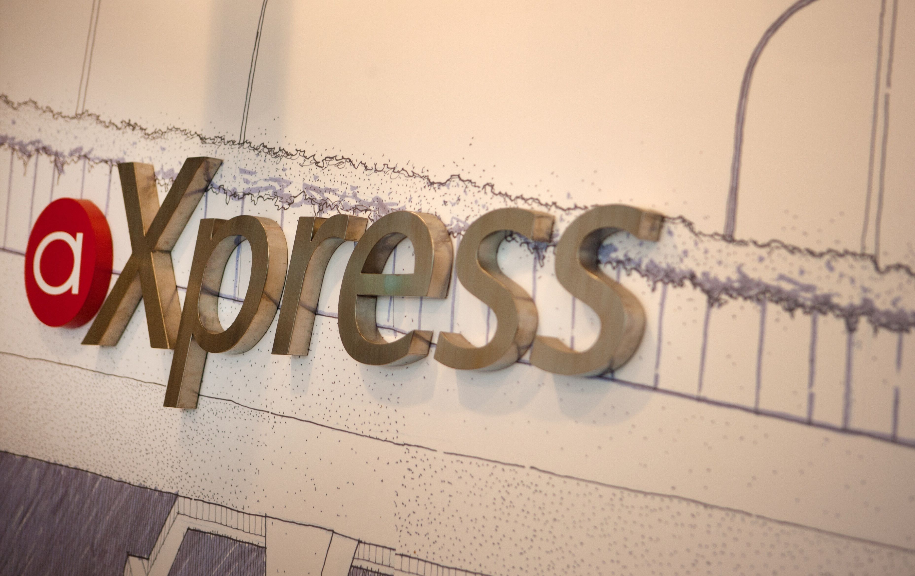 A wall with the word "Xpress" in large, metallic letters.