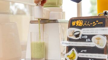 A person pouring a green liquid into a glass using a dispenser. A menu board with Japanese text is visible to the right.