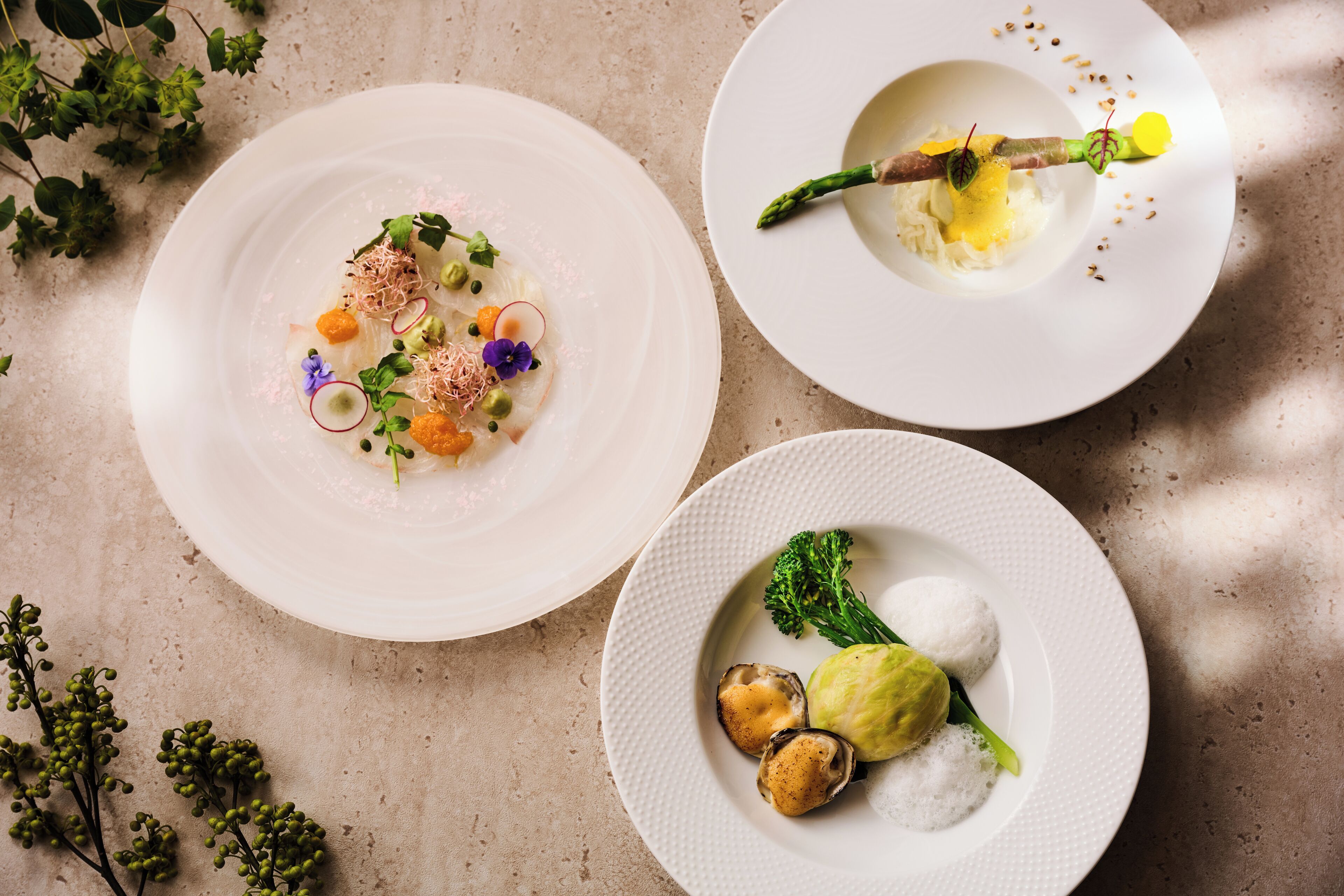 Three plates of food on a table.