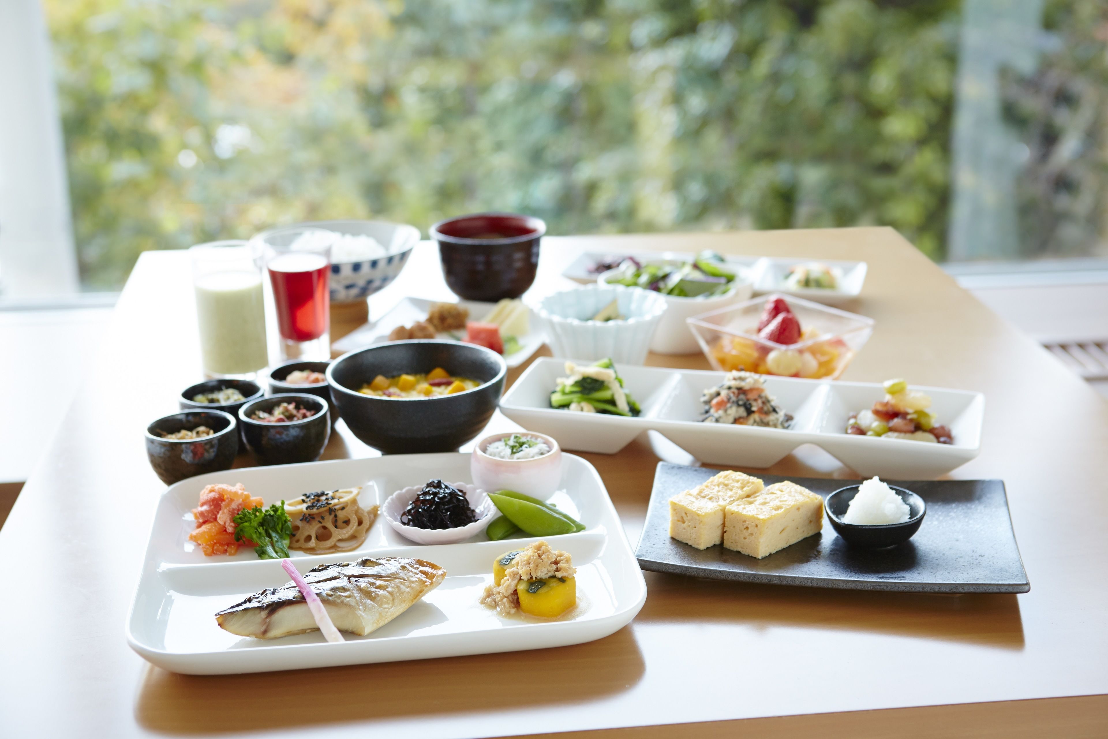A table with various dishes and drinks, likely for a meal or event.