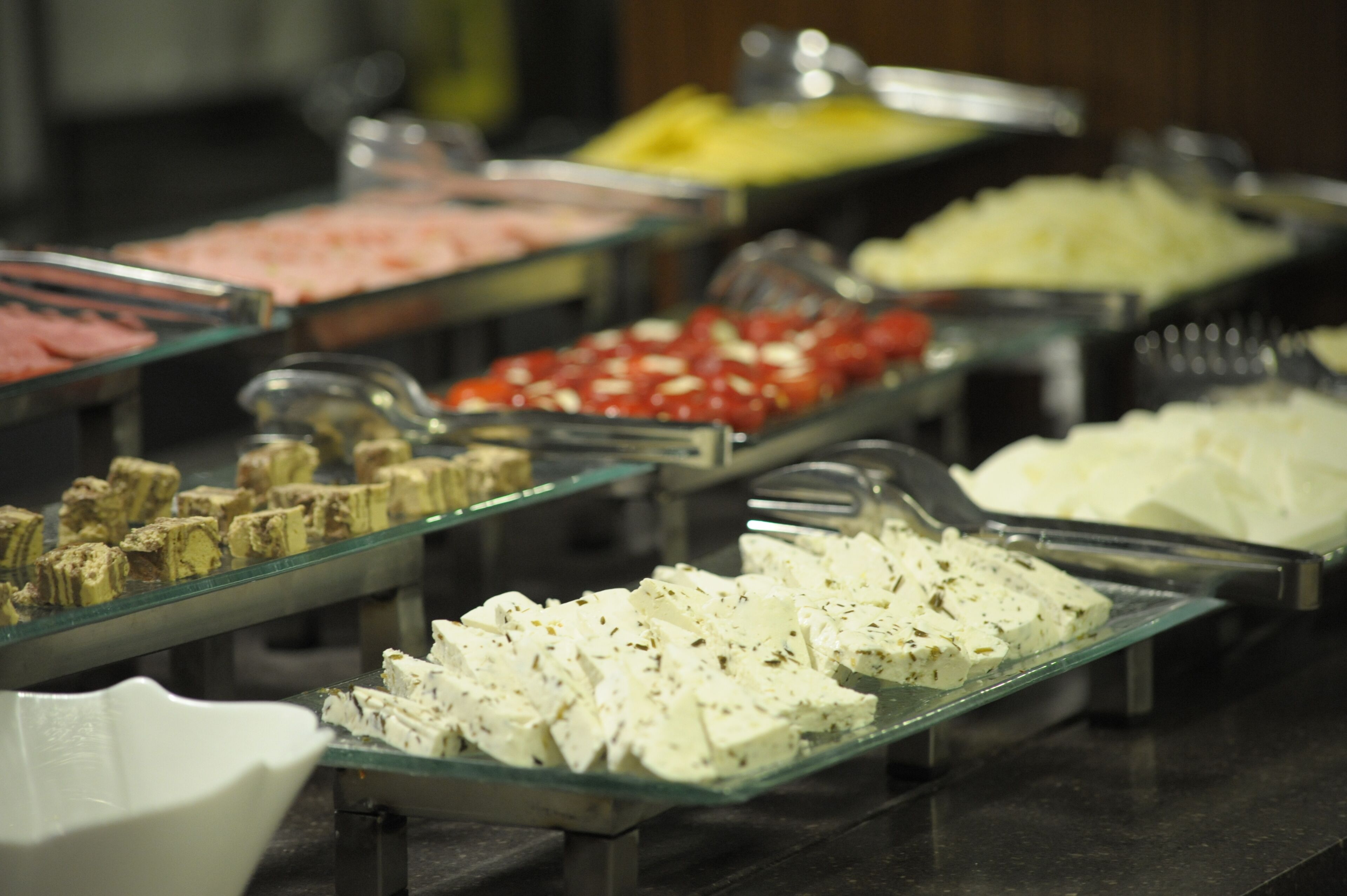 A buffet with various food items in glass containers.