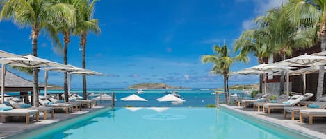 Piscine extérieure, parasols de plage, chaises longues