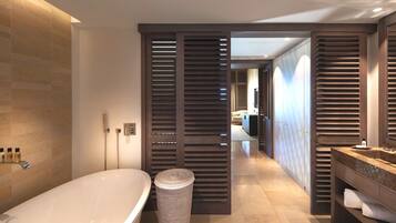 A modern bathroom with a freestanding bathtub, a toilet, and a sink.