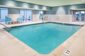 An indoor swimming pool with clear water, marked depth lines, and safety signs. - Holiday Inn Express & Suites Kingdom City by IHG (Kingdom City)
