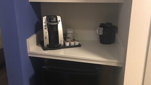 A kitchenette with a microwave, coffee maker, and a small refrigerator. - Holiday Inn Express & Suites Kingdom City by IHG (Kingdom City)