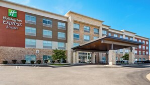 A Holiday Inn Express & Suites building with a modern design, featuring a brick facade, multiple windows, and a covered entrance. - Holiday Inn Express & Suites Detroit Northwest - Livonia by IHG (Livonia)