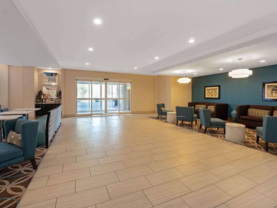 A spacious lobby with a modern design, featuring a mix of seating areas and a large open space.