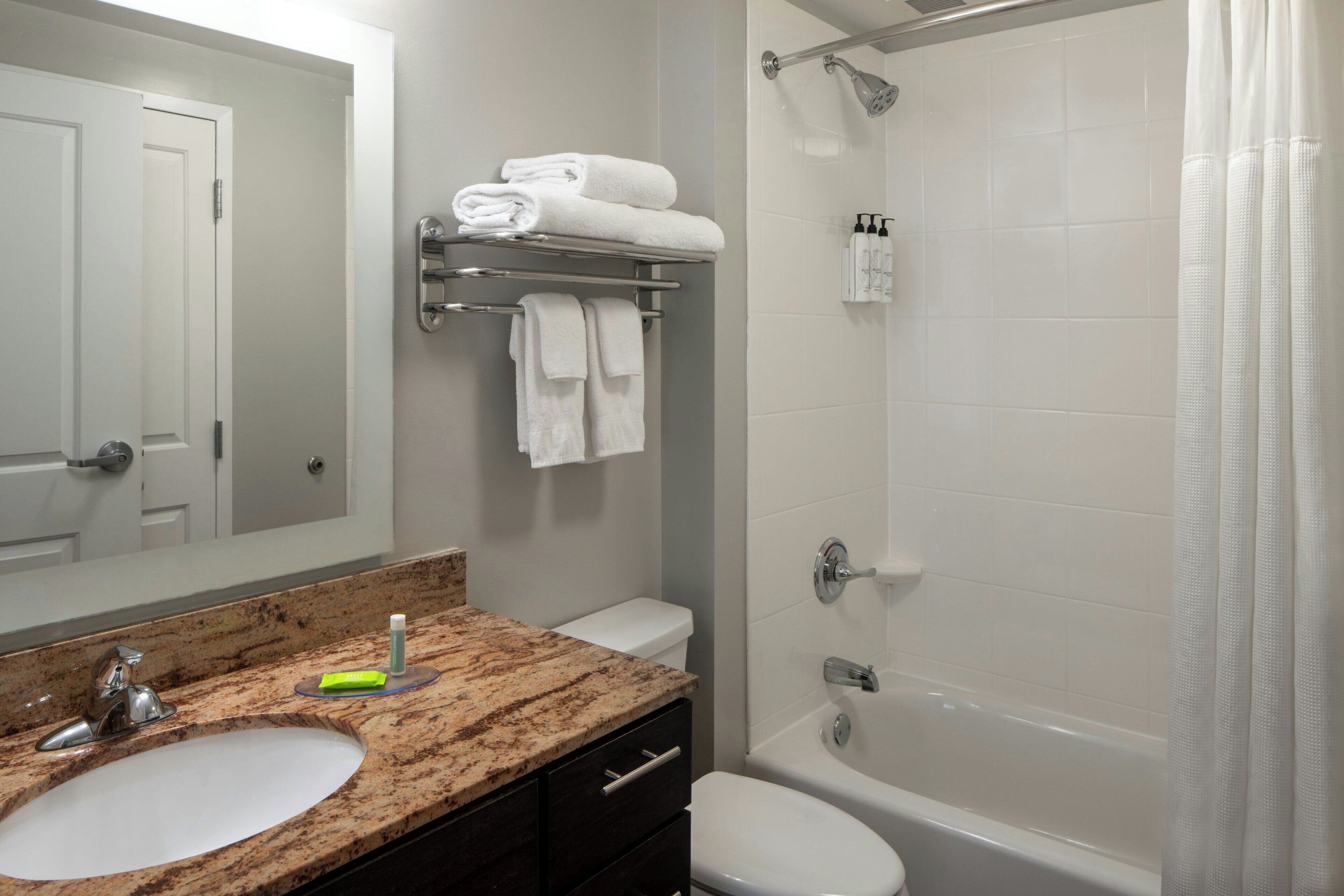 combined shower/bathtub, designer toiletries, hair dryer, towels