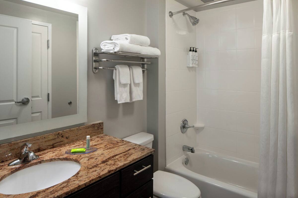 combined shower/bathtub, designer toiletries, hair dryer, towels