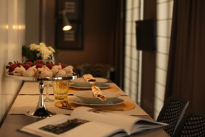 A dining table with a glass of beer, plates with food, and a book. - New Oporto Apartments - Cardosas (Porto)