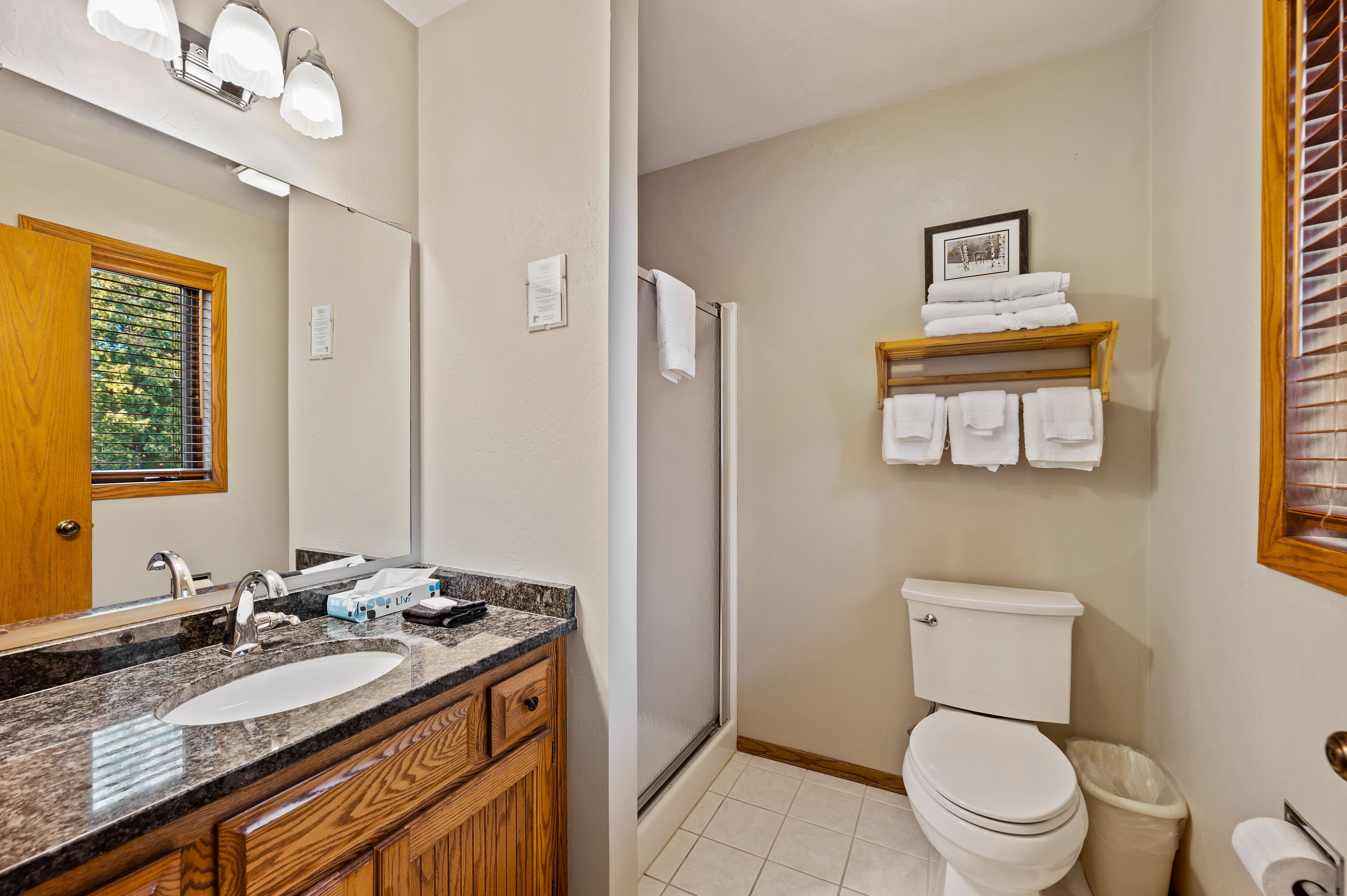 A bathroom with a sink, mirror, towel rack, and toilet.