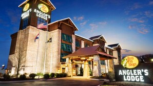 Un hotel con una torre destacada y un letrero que dice 'Angler's Lodge' y 'Bass Pro Shops'.
