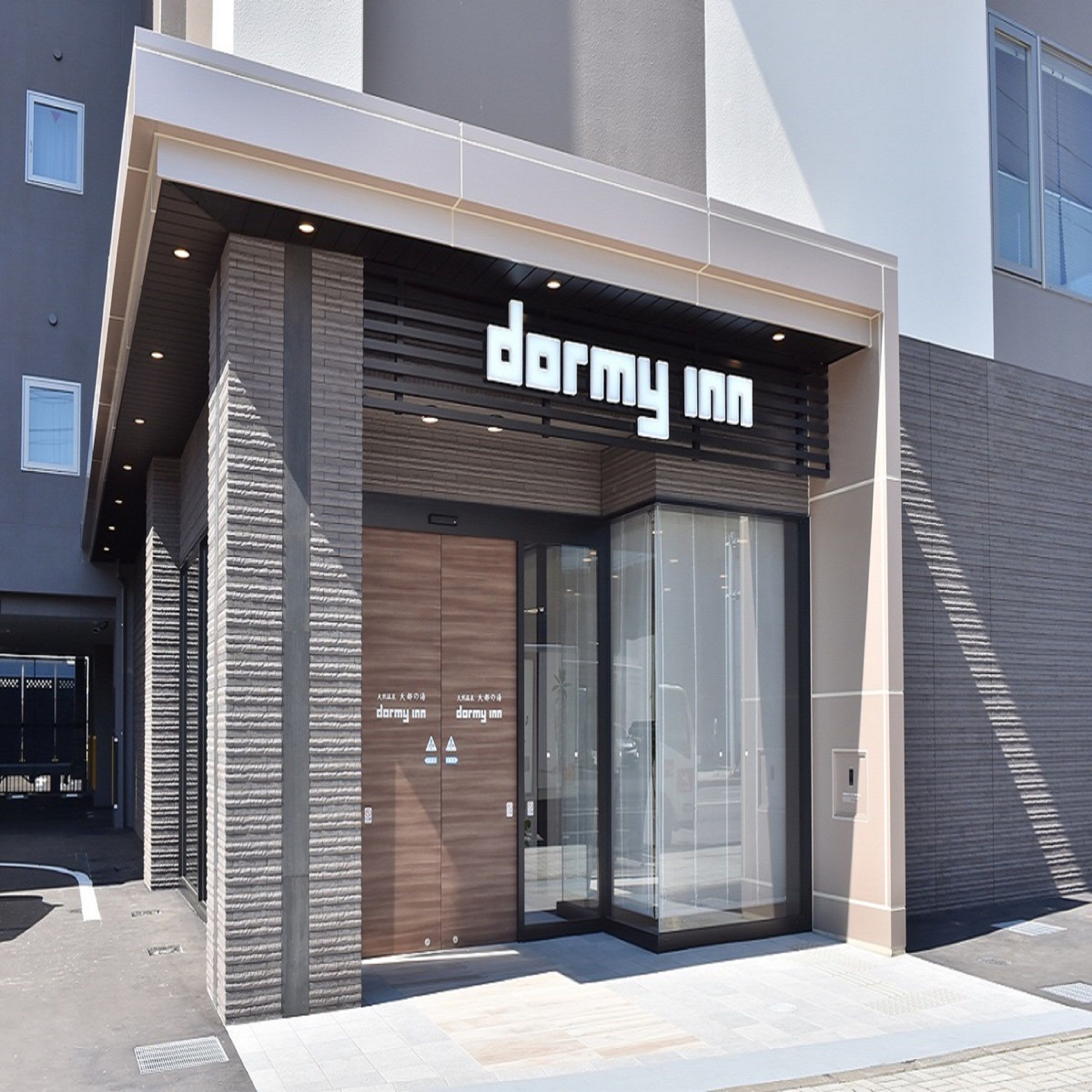 A modern building with a 'darmy inn' sign above the entrance.