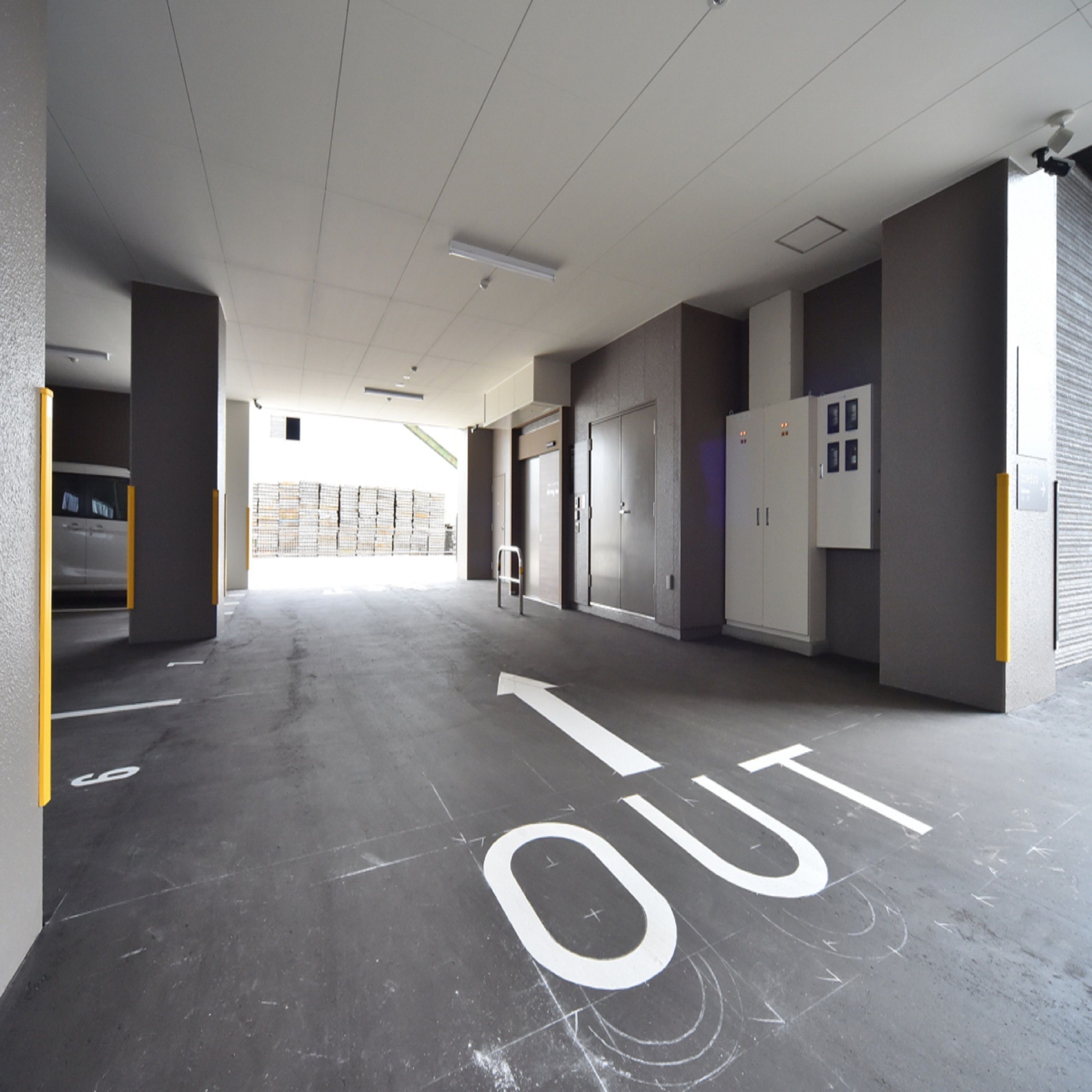 A parking garage with a clear exit path marked on the floor.