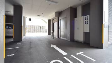 A parking garage with a clear exit path marked on the floor.