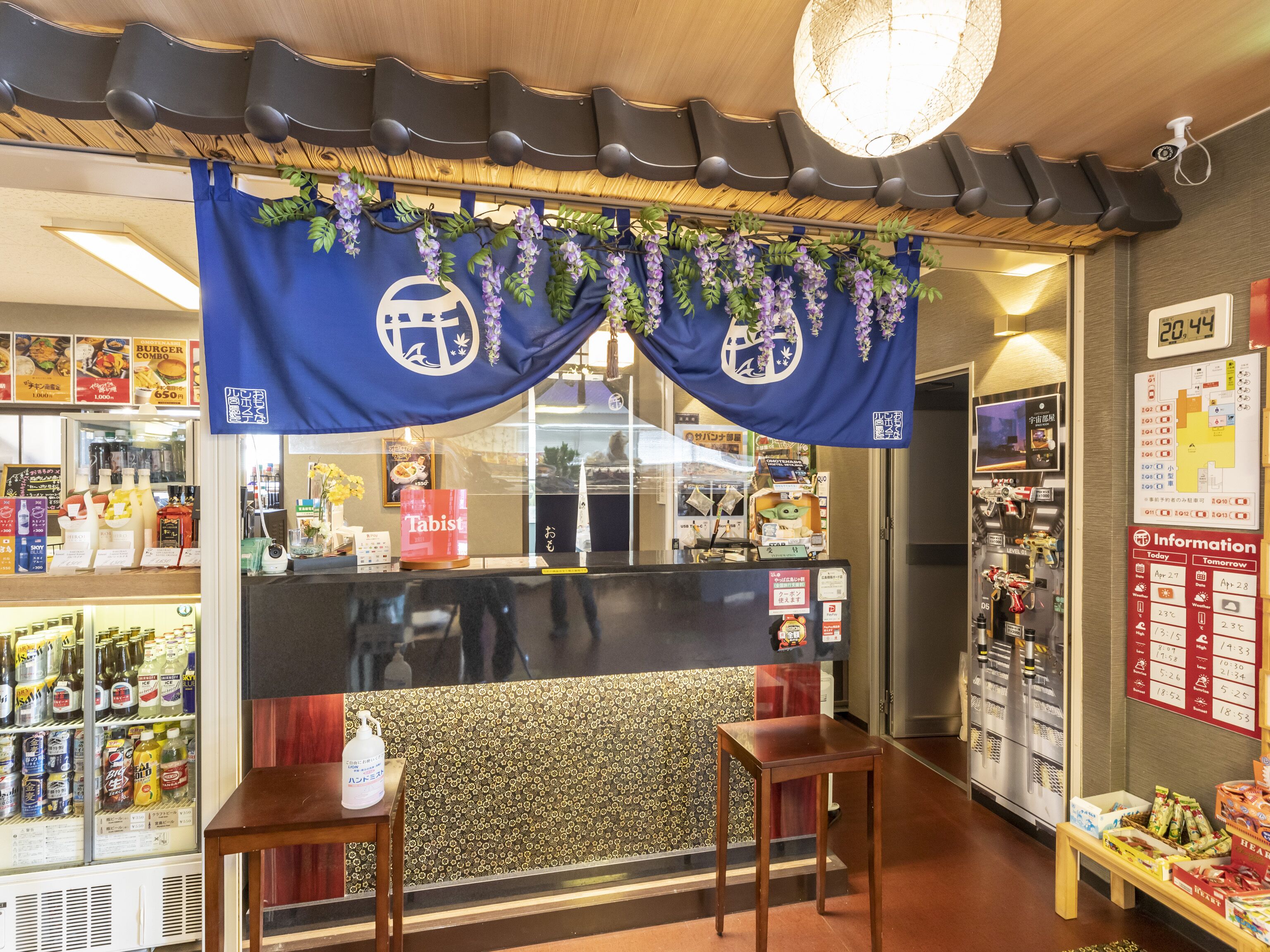 A restaurant interior with a counter, seating area, and various food and drink displays.