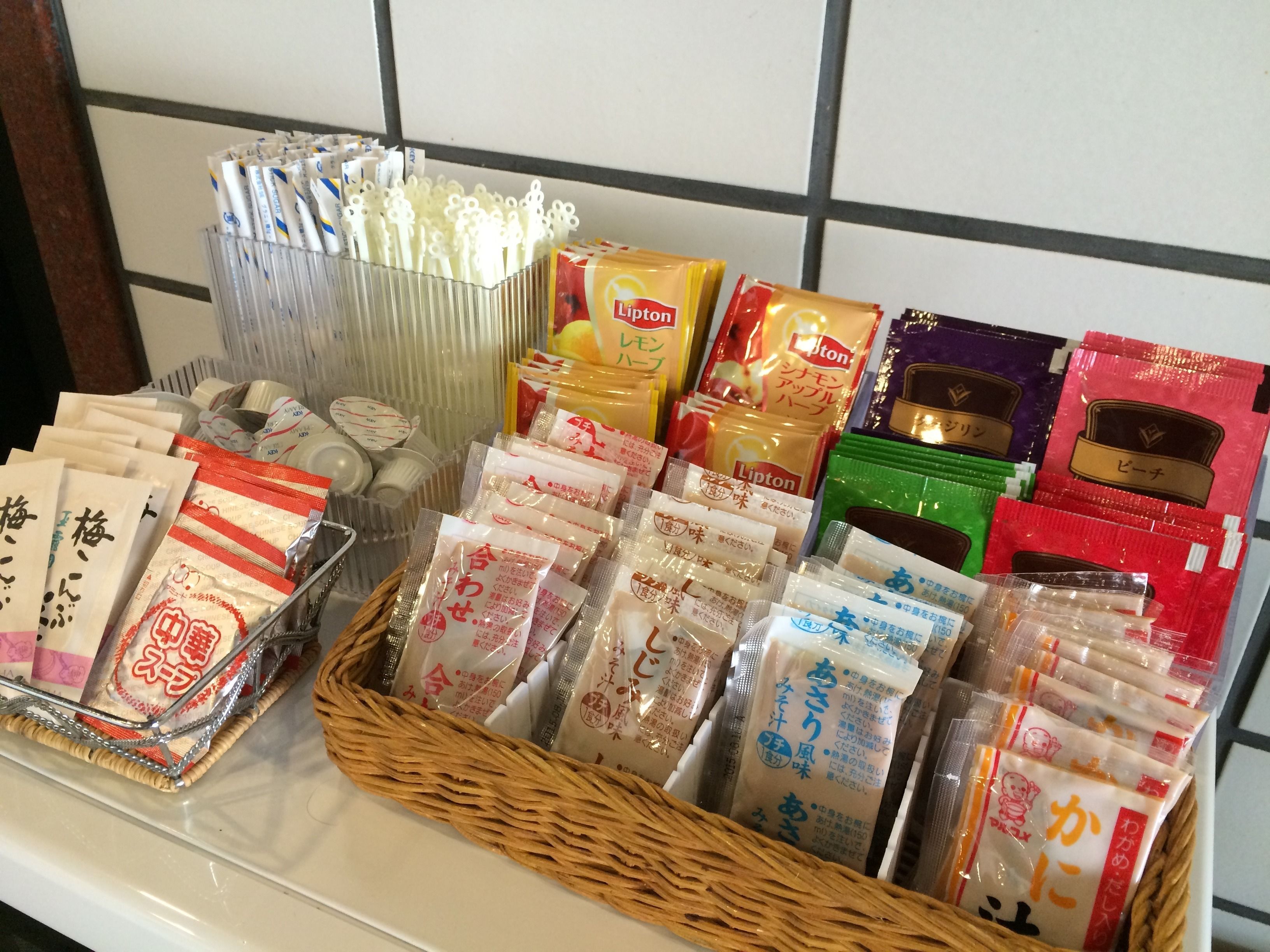 A variety of packaged goods, including Lipton tea and other snacks, arranged on a shelf.