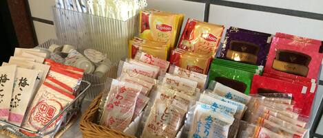 A variety of packaged goods, including Lipton tea and other snacks, arranged on a shelf.