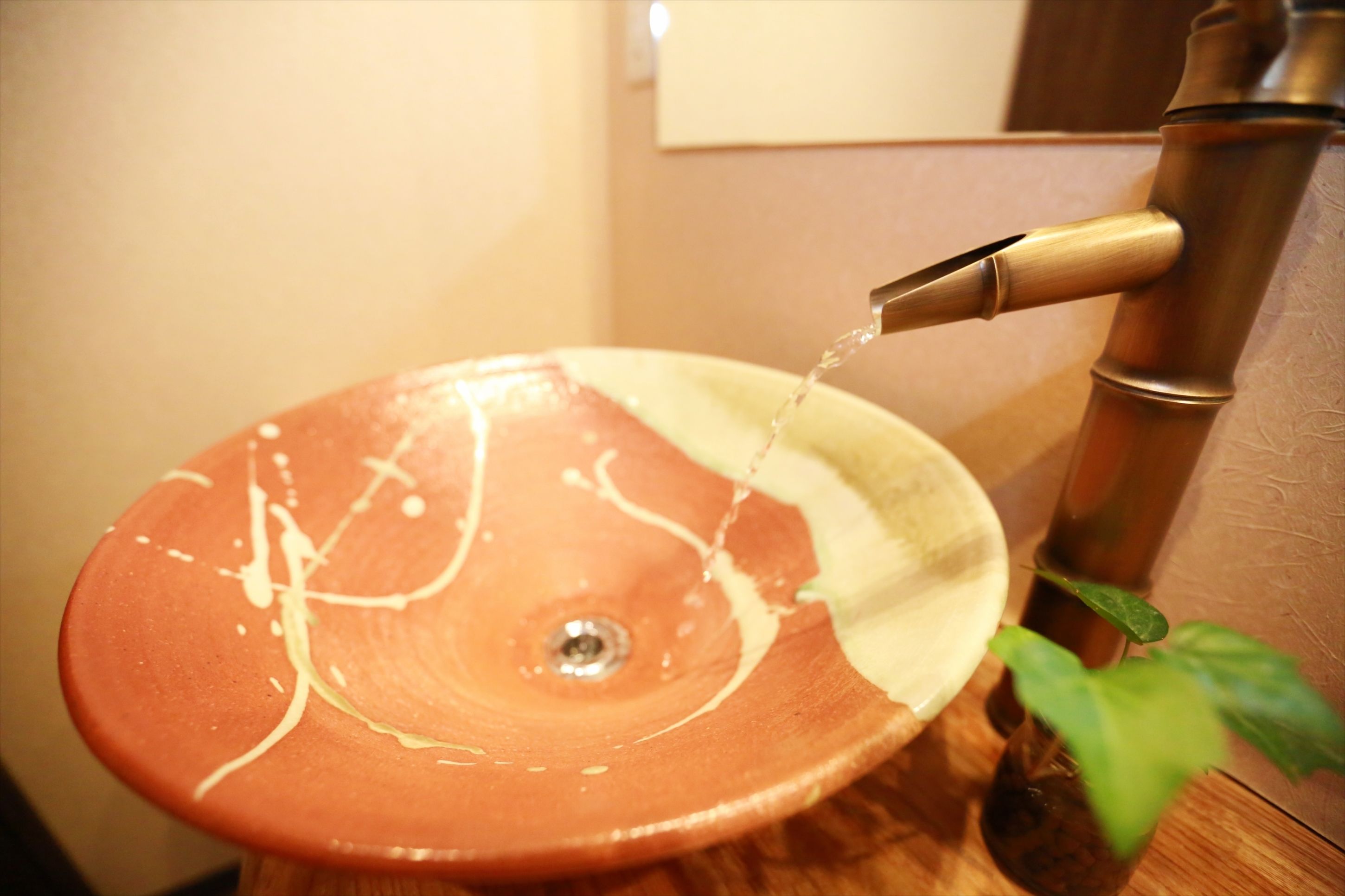 A ceramic sink with water flowing from a faucet.