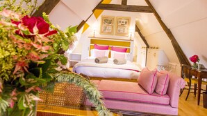 A cozy, triangular tent-style room with a bed, a sofa, and a small table. - Le Clos de Grâce (Honfleur)