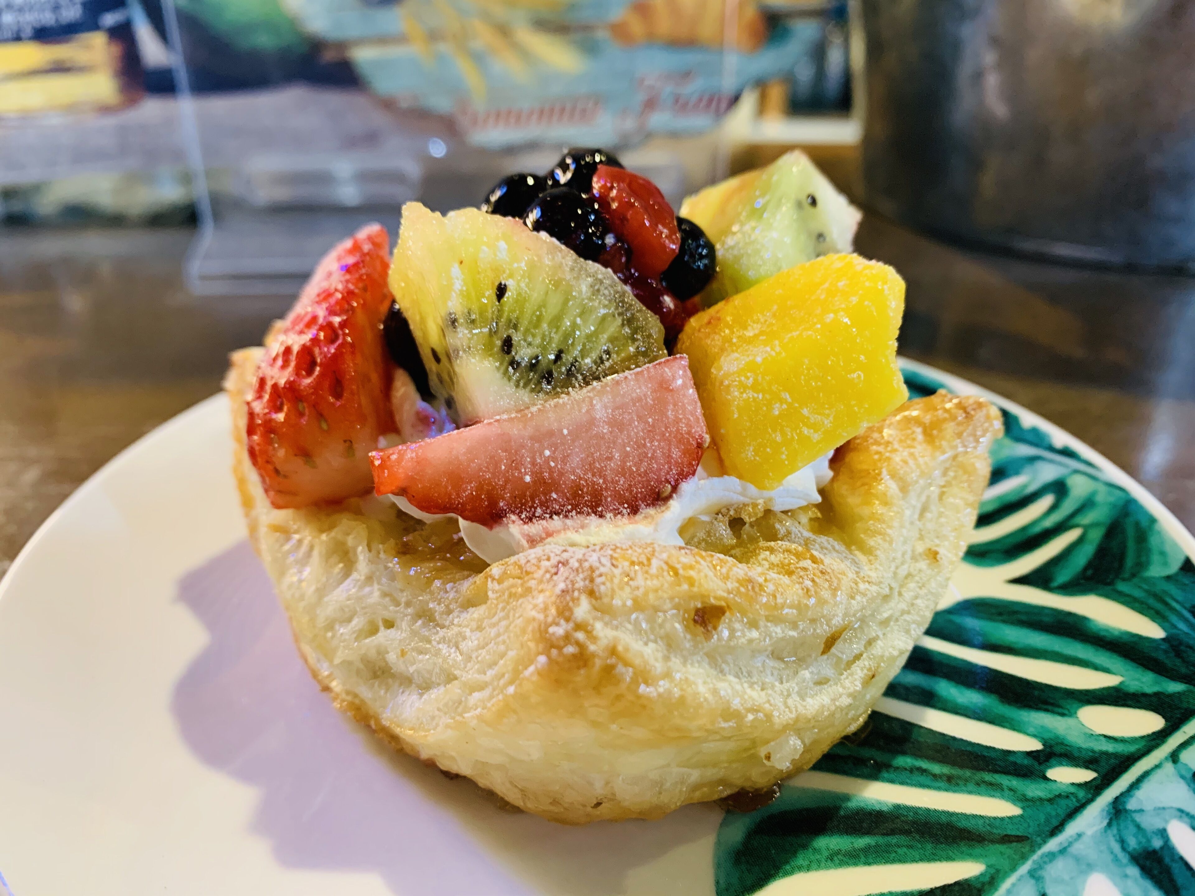 A pastry with various fruits on a plate.