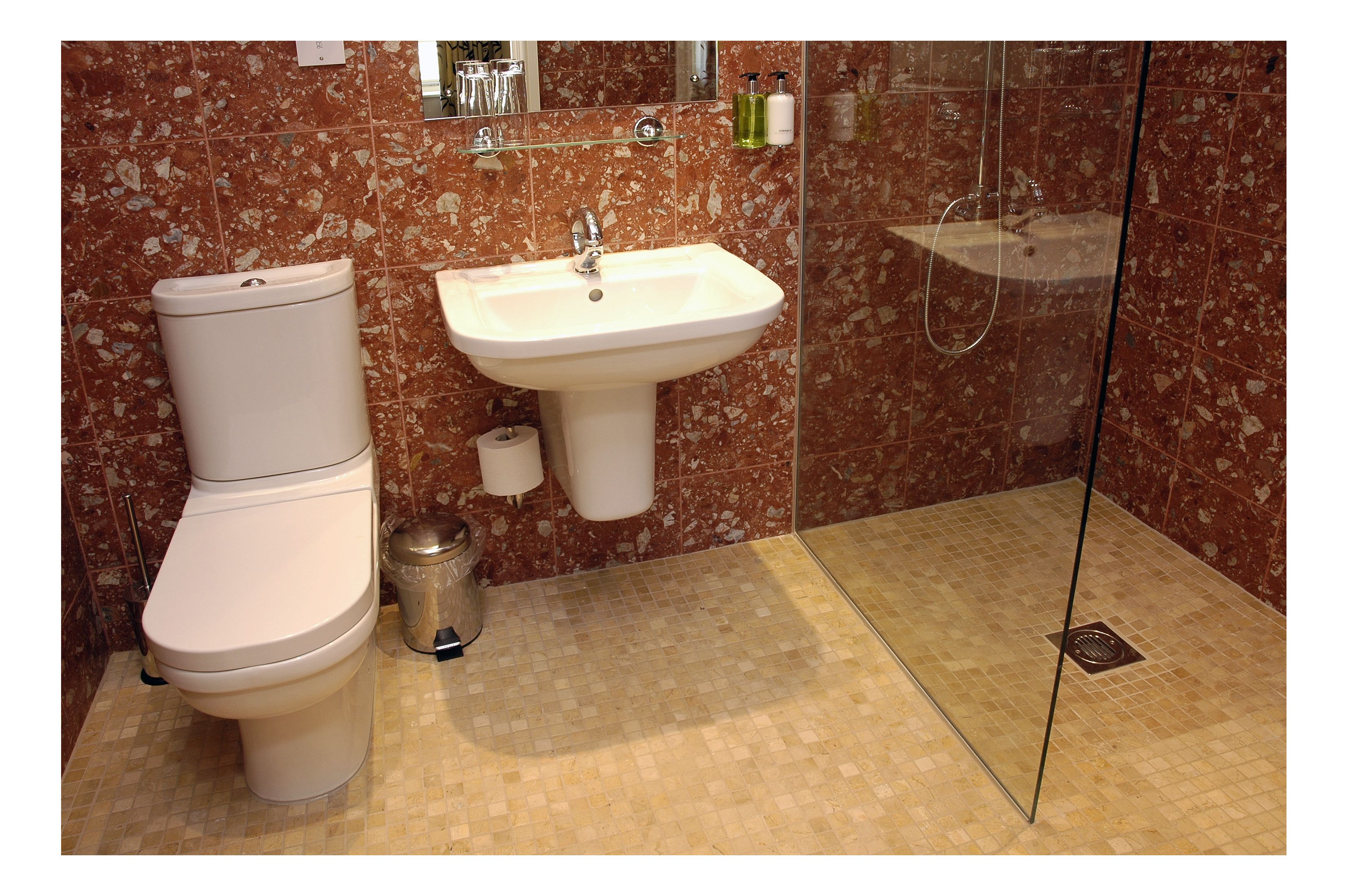 A bathroom with a toilet, sink, and shower.