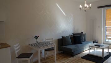 Apartment, 1 Bedroom, Park View | Living room | Flat-screen TV