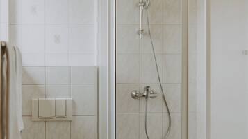 A bathroom with a toilet, a shower, and a bathtub.
