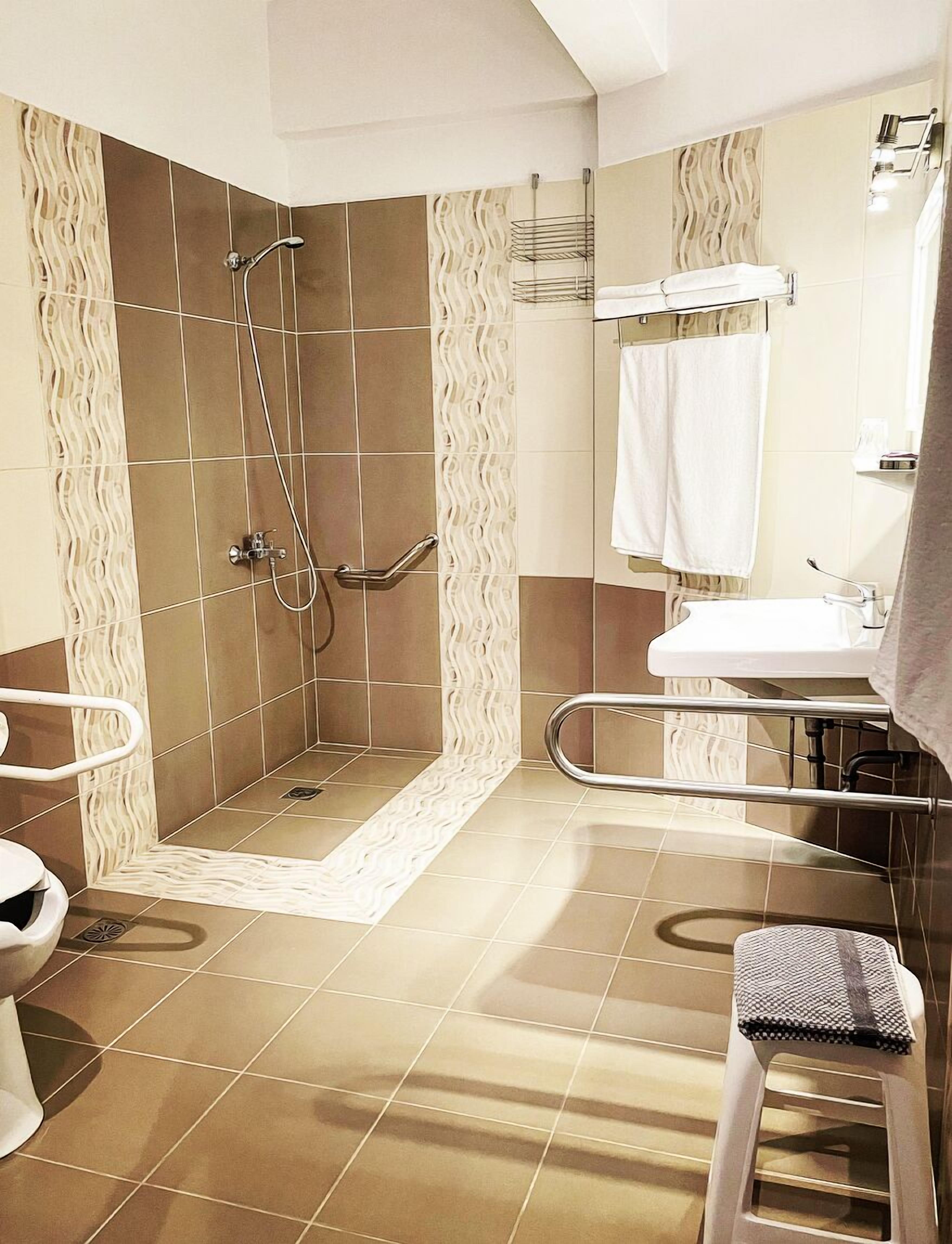economy quadruple room | bathroom | shower, hair dryer, towels