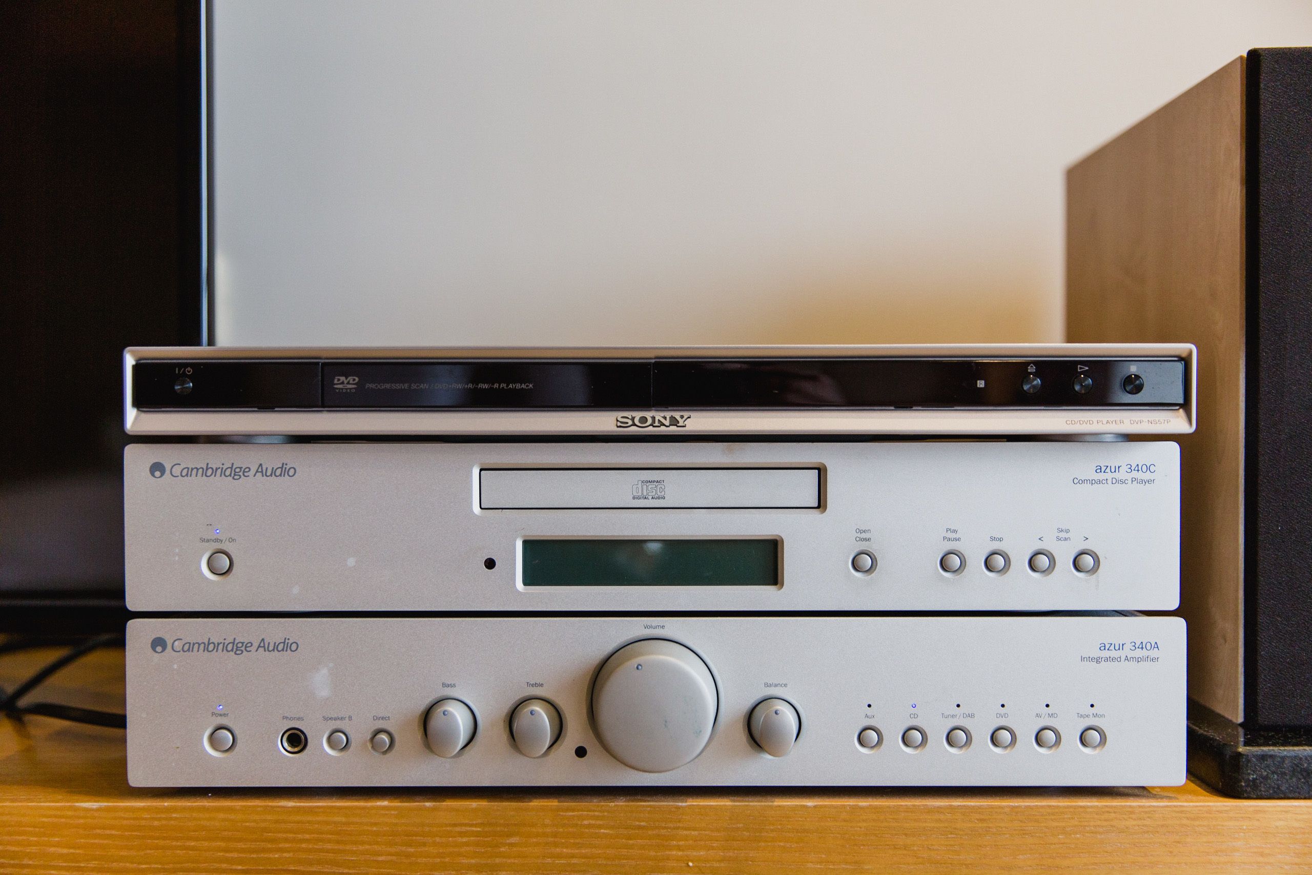 Two Cambridge Audio audio systems, one compact disc player and one integrated amplifier, on a wooden surface.