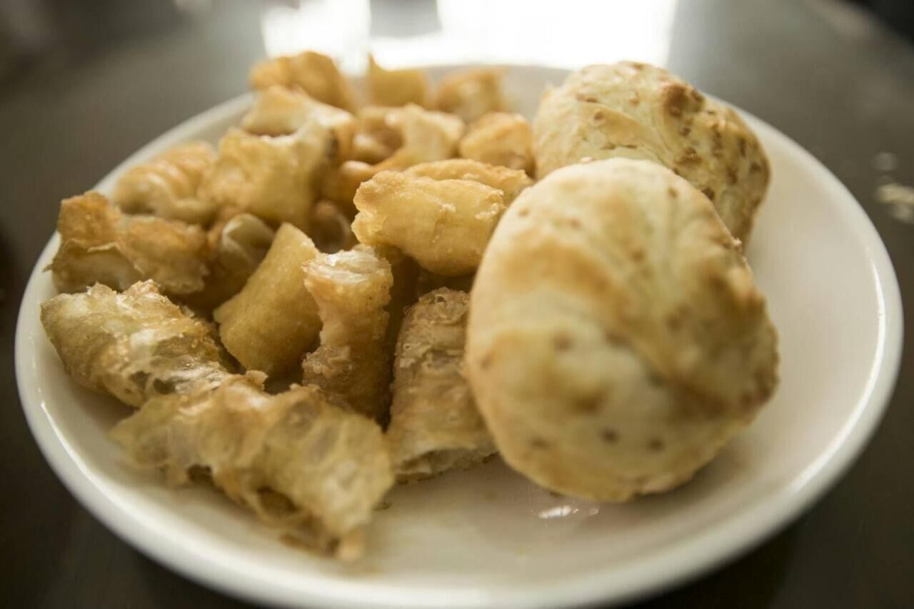 A plate of fried food items, including what appears to be fried chicken and possibly fried dough.