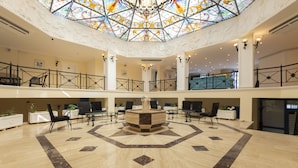 A spacious lobby with a central fountain, high ceilings, and a stained glass dome. - Soothe Hotel (Kas)
