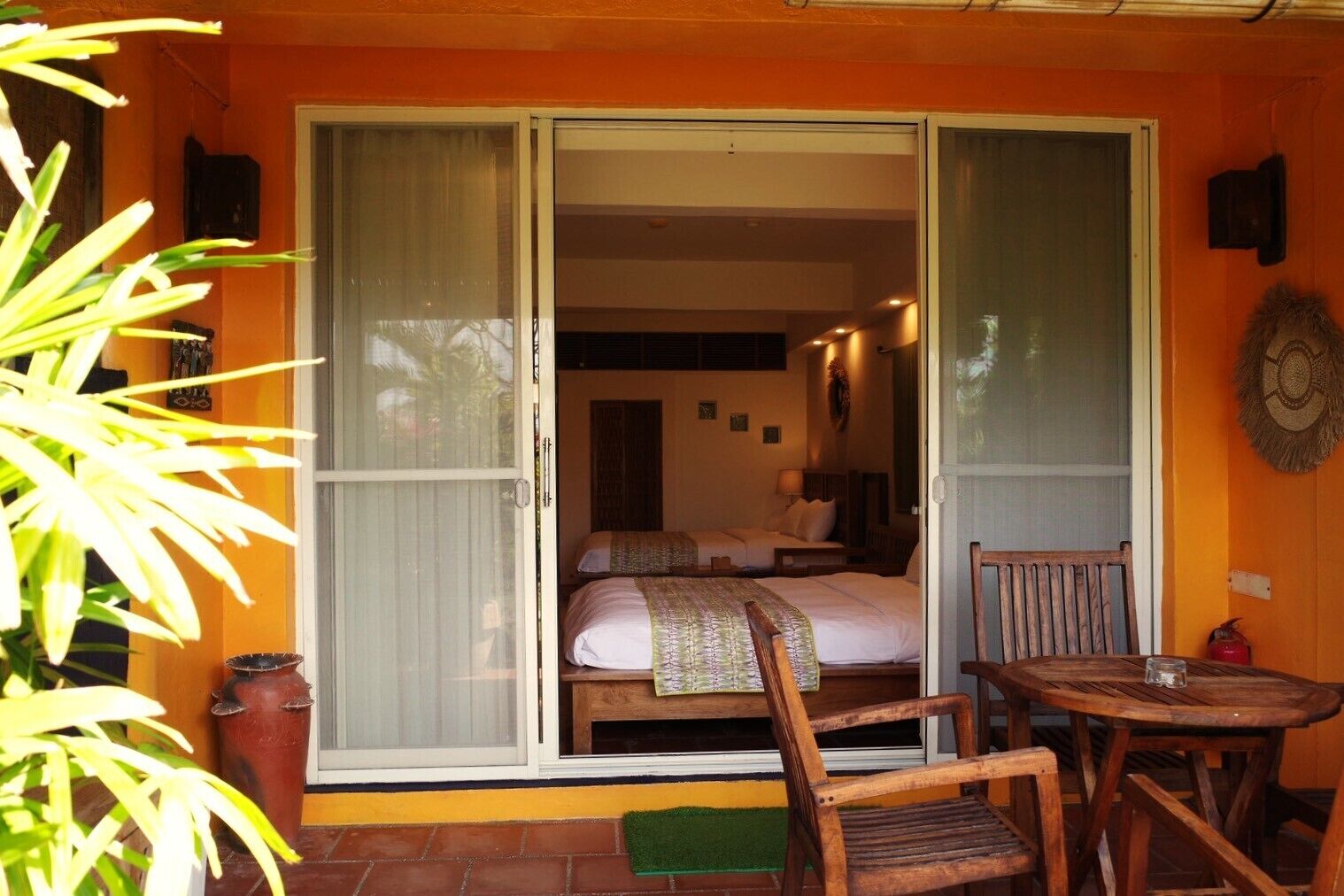 A room with a bed, a chair, and a table.