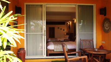 A room with a bed, a chair, and a table.