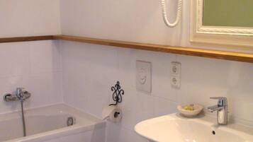 A bathroom with a bathtub, toilet, and sink.