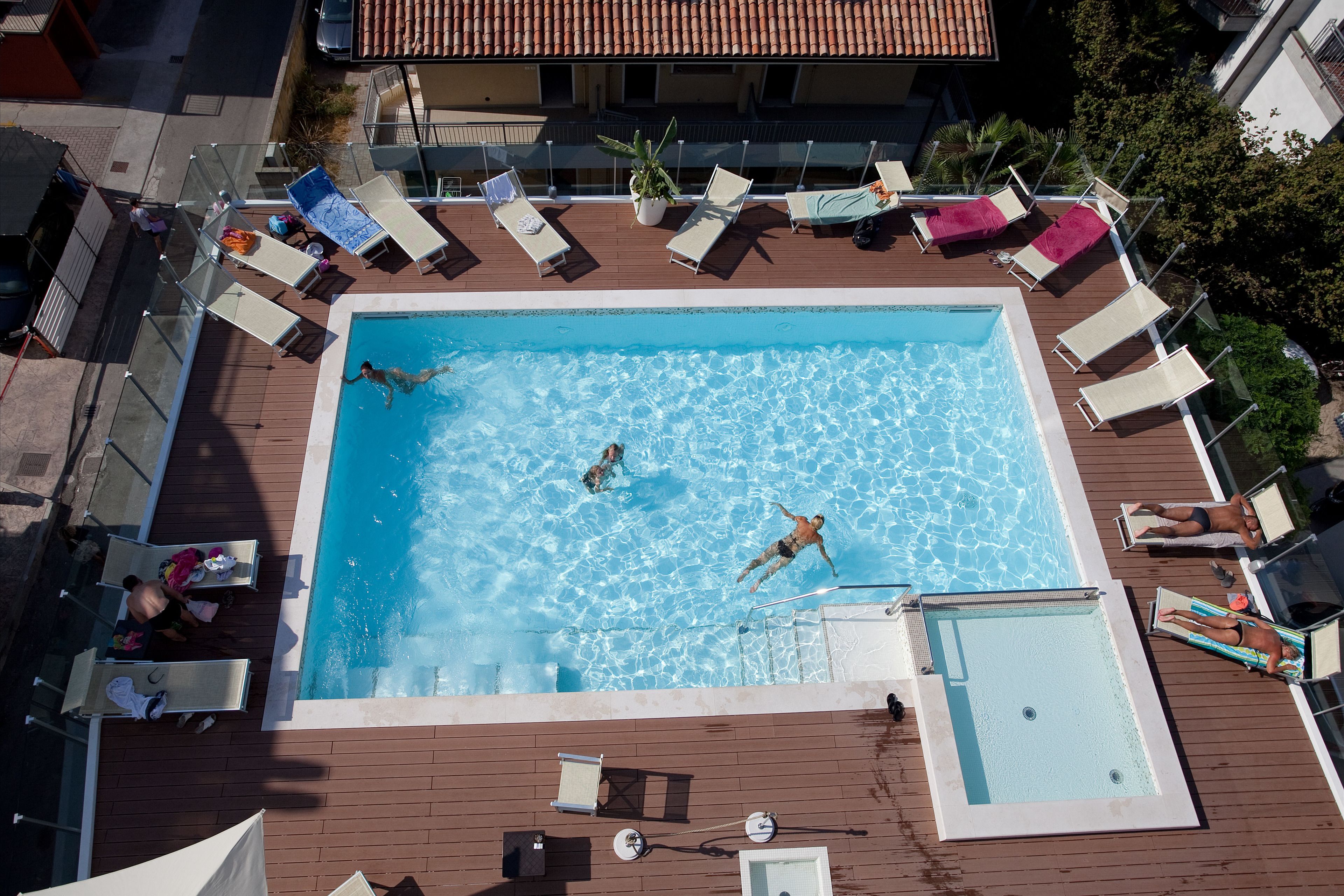 seasonal outdoor pool, a rooftop pool, pool umbrellas, pool loungers