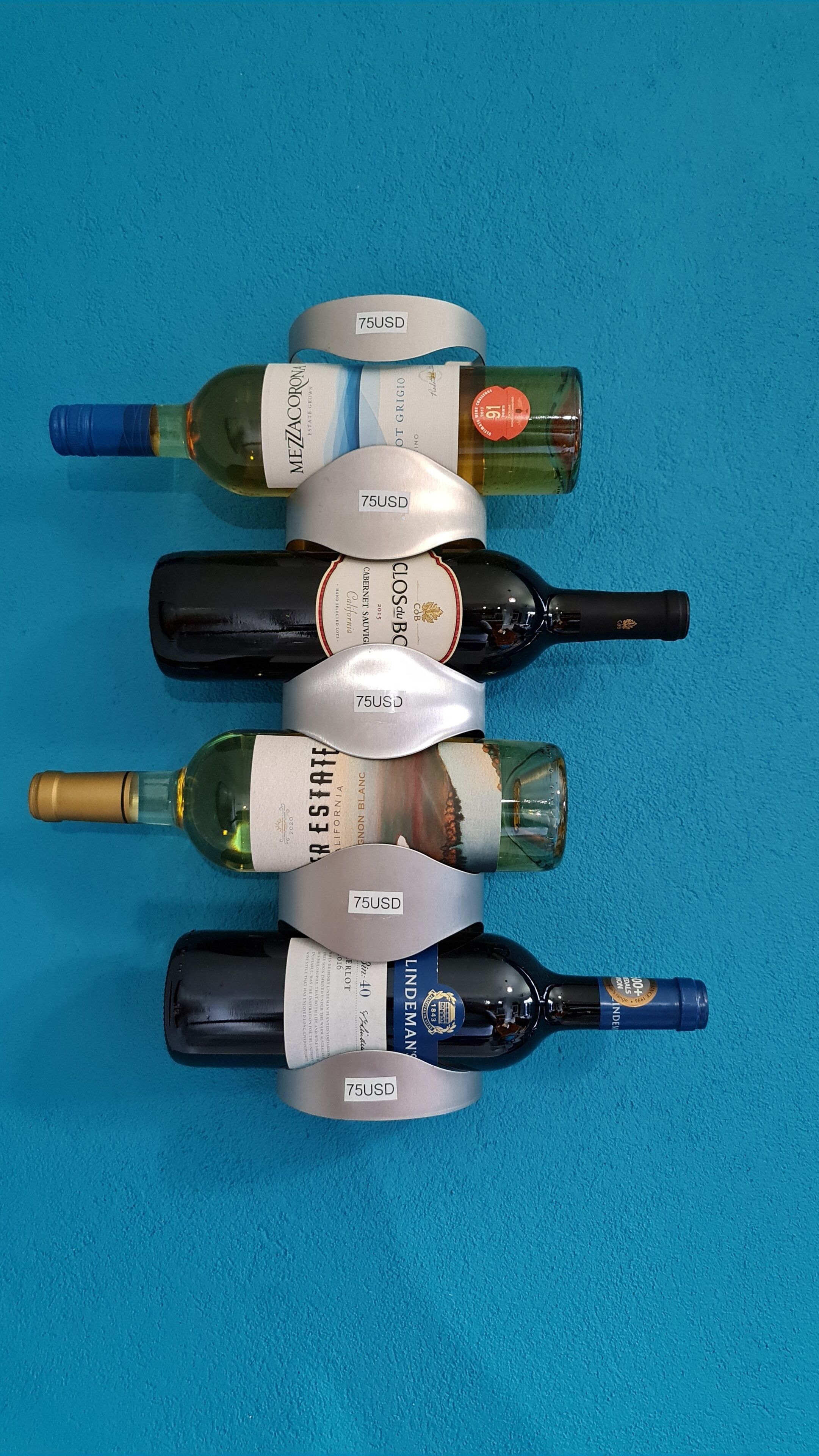 Five wine bottles arranged in a row on a blue background.