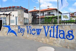 Experience the charm of Bay View Villas, where stone walls and red-tiled roofs blend seamlessly with balconies and a grand staircase.