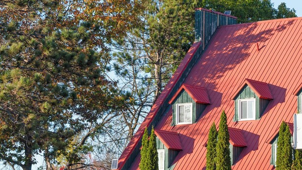 A building with a red roof, green siding, and multiple windows. - Hotel Cowansville (Cowansville)