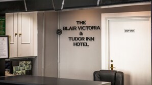 Zona de recepció amb un cartell que diu 'The Blair Victoria & Tudor Inn Hotel'.