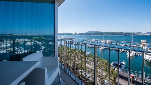 Un balcon avec vue sur un port de plaisance et des bateaux.
