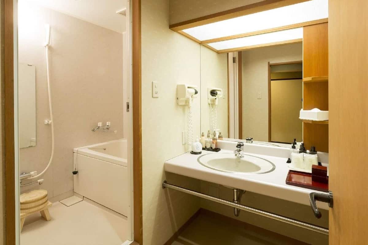 A bathroom with a bathtub, toilet, and sink.