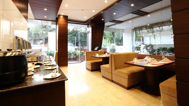 Un interior de restaurante moderno con mostrador, zona de estar y amplios ventanales.